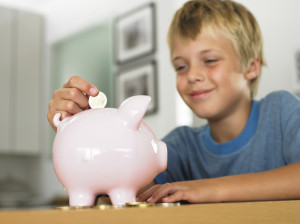 Child saving with piggy bank